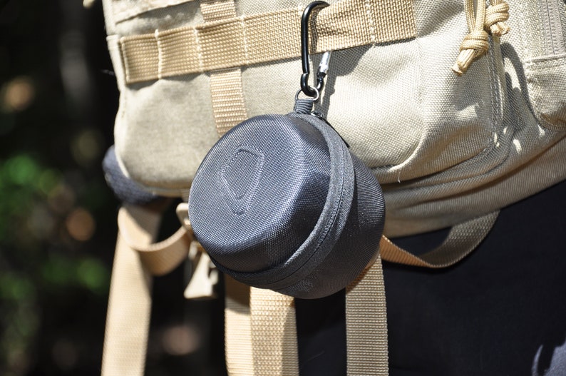 The Pocket Shot Survival Kit Hanging from Hiking Bag